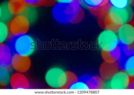 Christmas card, lights multicolored in blur, in the center there is a place for an inscription.