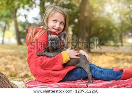 Little girl with Buldog puppy