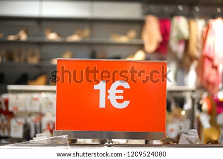 price one euro - inscription on a red background on the price tag in a clothing store during the sale                      