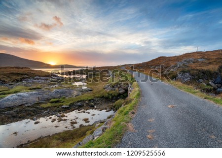 Beautiful sunset over the road that leads to Luskentyre on the Isle of Harris in Scotland Royalty-Free Stock Photo #1209525556