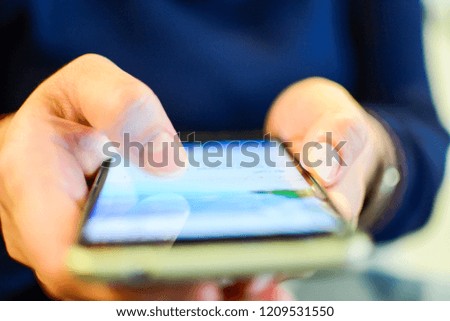 Lady's hand holding a cellphone. Selective focus. A broken smartphone screen. Copy space. Blurred background.