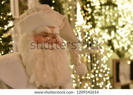 Coseup of Santa mannequin with Christmas lights in the background. Shallow DOF, space for copy.