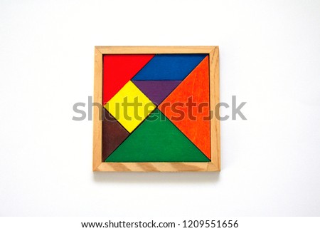 colorful wooden tangram set all pieces together in square box isolated