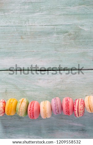 colorful macaroons on turquoise surface