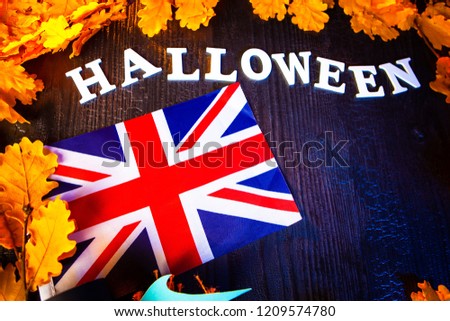 Halloween in UK. Union Jack surrounded with yellow oak leaves. United Kingdom flag and the inscription Halloween.