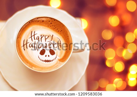 cup of coffee with the inscription happy halloween Royalty-Free Stock Photo #1209583036