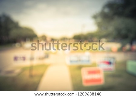 Vintage tone blurred row of yard signs at residential street for primary election day in Dallas county, Texas, US. Signs greeting early voters, political party posters for the midterm election concept