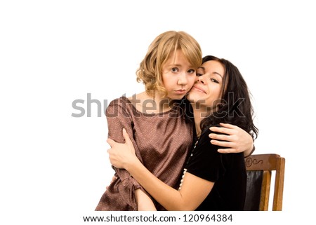 Attractive forlorn looking sad young woman being comforted by her friend who is smiling in an effort to cheer her up, on a white studio background