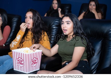 Group of female friends watching a movie in their home theater