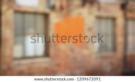 Out of focus grunge background of brick building seen in urban alley
