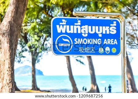 Signs for smoking areas at the beach in Songkhla, Thailand.
