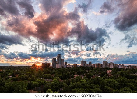 Summer sunset over midtown Toronto with sunburst