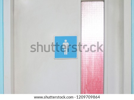 public men toilet sign on wooden textured door at the entrance with copy space