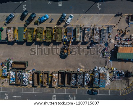 Aerial drone photo of rubbish recycling scrap tip with digger and cars parked in christchurch dorset england