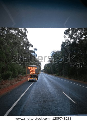 View from the motorhome of the forest road with road sign in the morning.