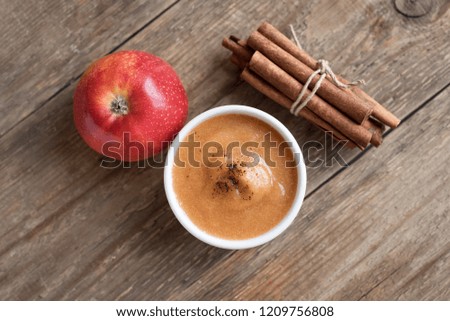 Apple sauce. Fresh homemade applesauce (apple puree, mousse, sauce) with cinnamon and apples on wooden table, copy space