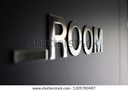 Room sign on black door