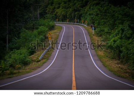 asphalt road.Yellow line on the asphalt road in country side of Thailand.
