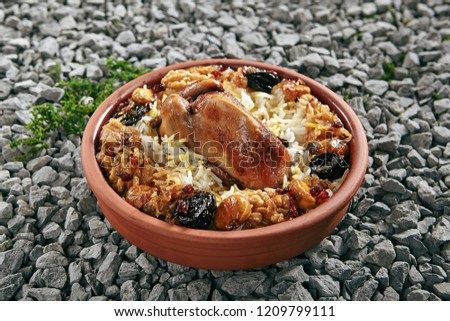 Beautiful Serving Vintage Ceramic Bowl of Lyavangi or Lavangi with Roast Quail with Rice and Chestnuts Close Up. Whole Chicken Pilaf or Wildfowl Stuffed with Walnuts, Onions and Various Condiments