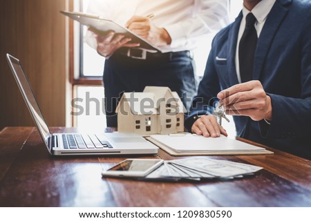Real estate agent and Sales manager team analysis pricing of rental lease contract of sale purchase agreement, concerning mortgage loan offer for and house insurance. Royalty-Free Stock Photo #1209830590