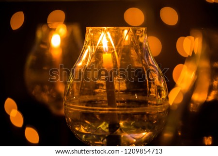 candle in glass lantern at the night. Buddha candle. Image has shallow depth of field.