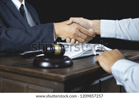 Congratulation and collaboration concept, Shaking hands after good cooperation, Businessman handshake with male lawyer after discussing good deal of contract in courtroom.