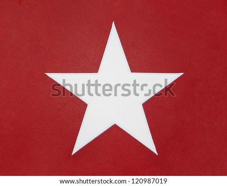White leather star isolated on red leather background.