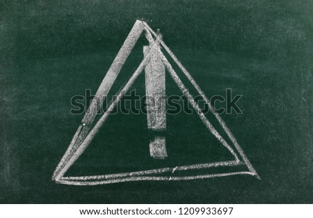 Danger triangular road, traffic sign with exclamation mark drawn on chalkboard, blackboard background, texture