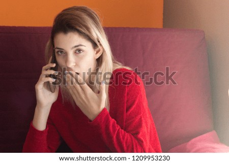 pretty young girl at home with mobile phone