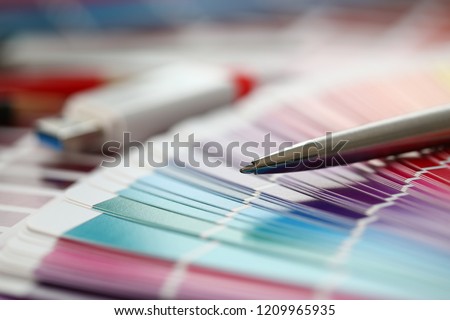 Stationery and USB flash drive on design background. Color print of pantone statistics offset organization gives customer an order products for distribution during promotion concept