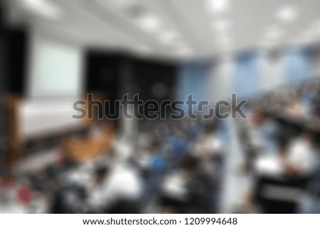 Blur abstract background of examination room with undergraduate students inside. Blurred view of student doing final test in exam hall.