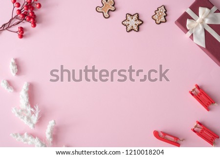 Winter Christmas table layout with New Year decoration on pastel pink background. Minimal nature concept. Flat lay top view composition.
