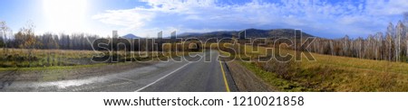 Panorama of a good, asphalt mountain road from Gorno-Alltaisk to Artybash loops among the fields and hills of Gorny Altai. The picture was taken on an autumn day, with natural light.
