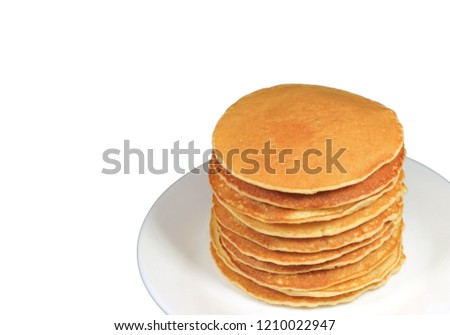 Stack of homemade plain pancakes served on white plate isolated on white background with free space for text and design