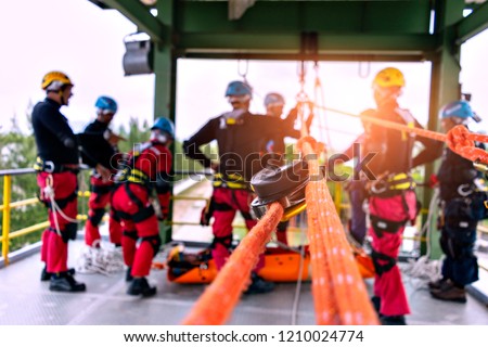 Rescue team in action practicing training for the use of ropes for rescue of high buildings . selective focus .  Concept for team ,teamwork and rescue. Royalty-Free Stock Photo #1210024774