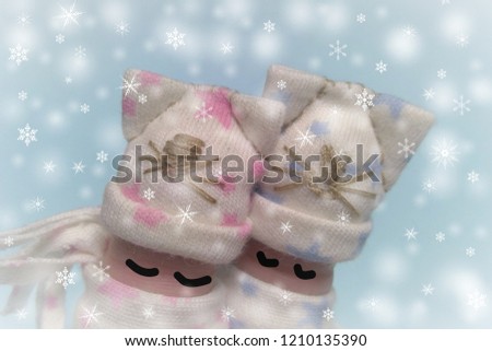 nice picture of fingers wearing a funny hat and scarf. winter weather. relationship between people. holiday card.