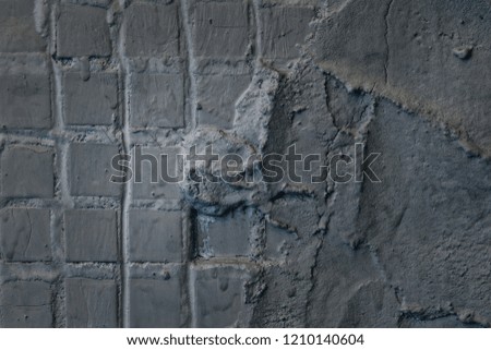 the mysterious gray wall of the old building is partially covered with small square tiles and the other part is smeared with a solution of granite background for the design