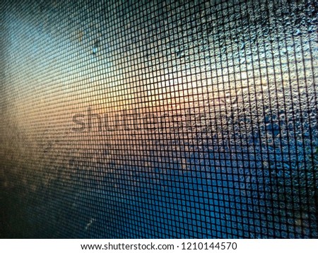 mosquito net wire screen on the window with water drops