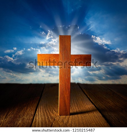 Christian wood cross on blue sky wooden made background