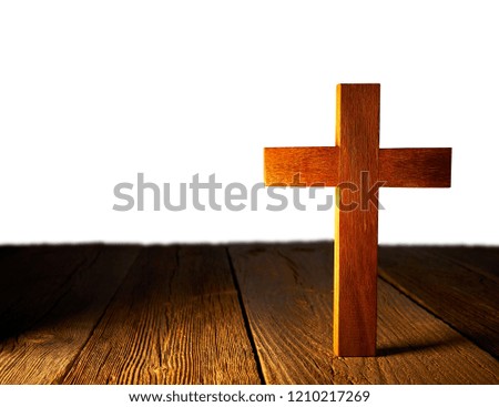 Christian wood cross on white and wooden background