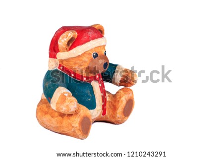 little bear dressed for christmas on a white background in studio