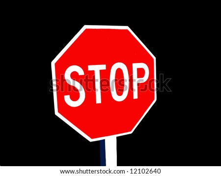 A stop sign isolated on black.