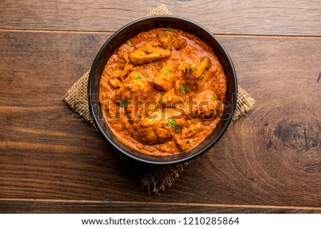 Murgh Makhani / Butter chicken tikka masala served with roti / Paratha and plain rice along with onion salad. selective focus Royalty-Free Stock Photo #1210285864