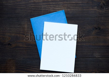 Empty blank for your text with pencils at dark wooden background, flat lay mock up