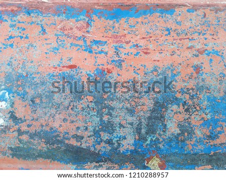old wood painted peeling from the weather, artistic motif with colors red, blue, white, pink