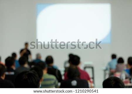Blur photo of speakers talking in meetings. Audiences in the meeting room businesses and entrepreneurs are looking at the screen with interest.