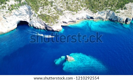 Aerial drone bird's eye view photo of tropical rocky bay of Ortholithos with famous cave of Papanikolis and turquoise calm waters forming a blue lagoon