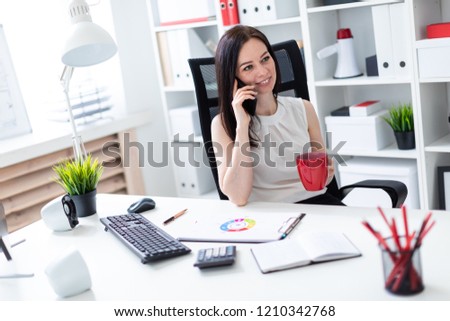 Beautiful young girl working in a bright office. Young girl in white blouse and black skirt. photo with depth of field
