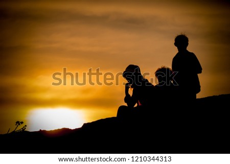 Silhouette of a family sweet enjoying a beautiful sunset