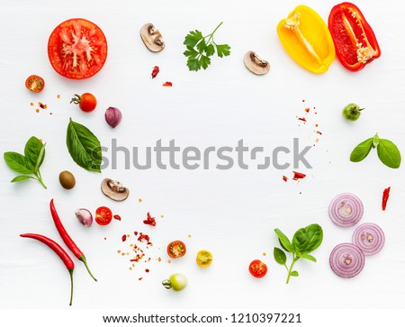 The ingredients for homemade pizza on white wooden background. Royalty-Free Stock Photo #1210397221